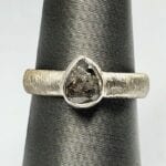 Teardrop gemstone with pure silver band