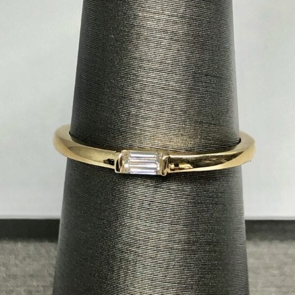 gold baguette ring on ring stand