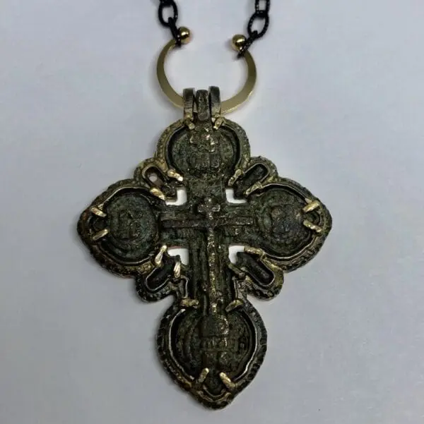 Gold and black cross pendant