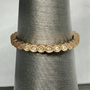 Circular gold band embedded with diamonds