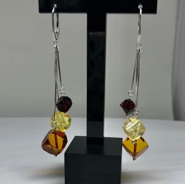 Closeup amber drop earrings tricolor